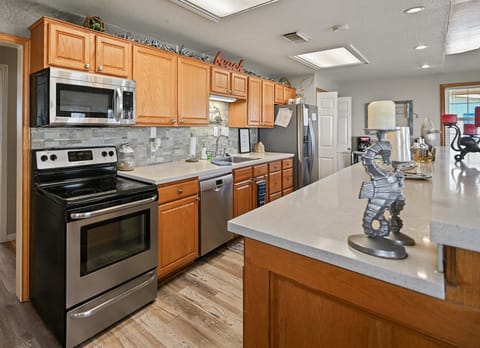 Beautiful kitchen with quartz counter-top, tile back-splash & an single sink