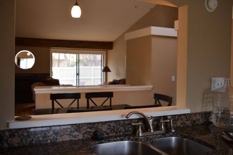 Kitchen views of dinning, living , fireplace and outdoor dinning .