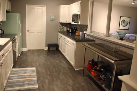Kitchen view from other end, bar & great room on right. Tons of counter space!