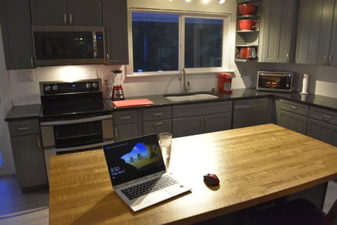Modern appliances and the kitchen is stocked with cookware.
