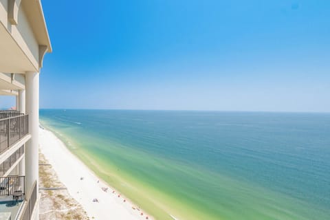 Breathtaking top-floor views of the tranquil coastline and vibrant blue waters from a spacious balcony