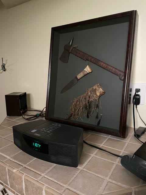 Bose radio/cd player with replica “Last of the Mohicans” knife and tomahawk. 