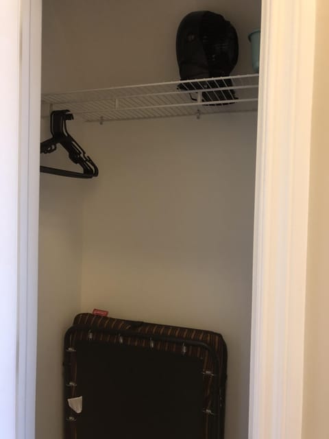 Closet in Bathroom with a cot and a fan (as a noisemaker, if you want )