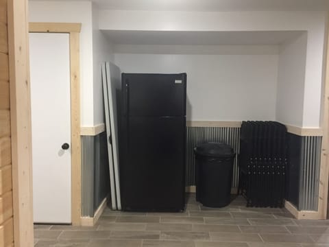 Extra fridge, tables, and chairs