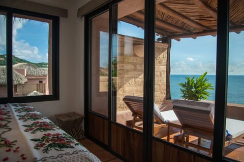 Oceanfront Terrace Suite | Free minibar items, in-room safe, individually decorated