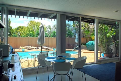 newer photo View from inside the home with ceiling to floor windows