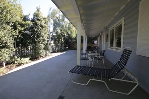 large tree linked patio for relaxing and kids to play. At front of house