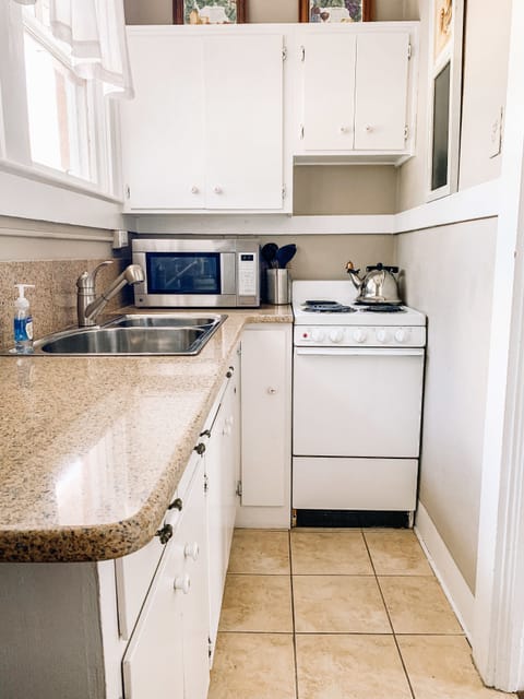 The Coastal Cottage | Private kitchen | Microwave, coffee/tea maker, cookware/dishes/utensils, paper towels