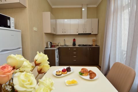 Family Apartment, 3 Bedrooms | Private kitchen | Fridge, microwave, stovetop, coffee/tea maker