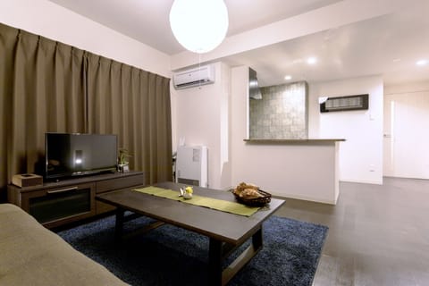 Deluxe Room, 3 Bedrooms, Kitchen | Living area | Flat-screen TV