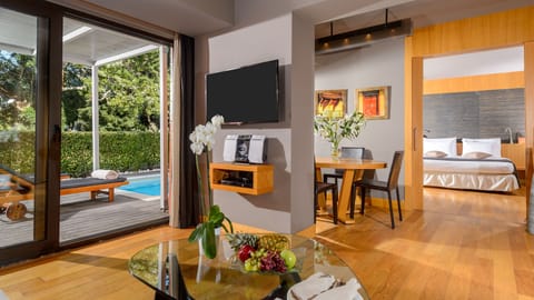 Deluxe Suite, Private Pool | Living room | 42-inch LCD TV with satellite channels, TV