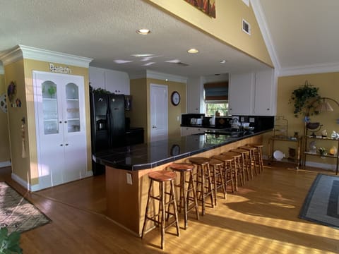 Pull up a chair at the dining table or a stool at the counter, room for everyone