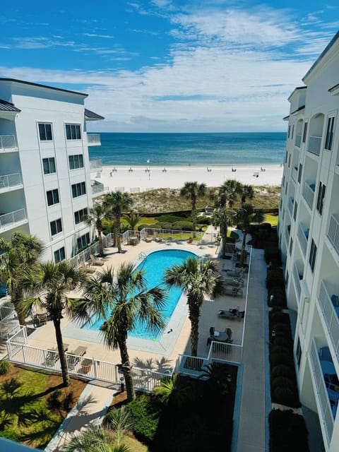 View of pool courtyard and Gulf of Mexico from the unit balcony.