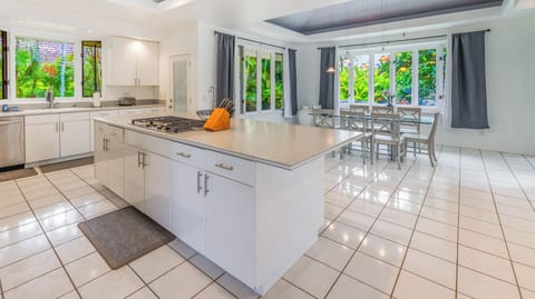 Spacious, open-concept kitchen and dining area with charming country style table- perfect for a family dinner