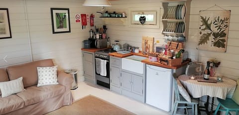 Lounge and Kitchen Area at Cuttermoon Lodge. The lounge has a double sofa bed