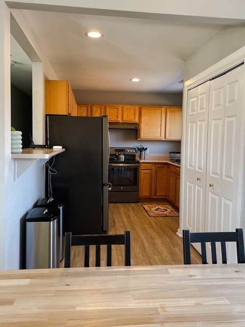 The kitchen is well stocked with cookware, cooking utensils, and spices.
