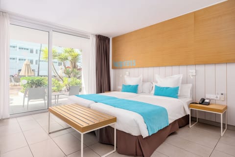 Deluxe Room, Pool View | In-room safe, desk, laptop workspace, blackout drapes