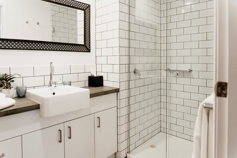 Motel Suites | Bathroom | Shower, rainfall showerhead, designer toiletries, hair dryer