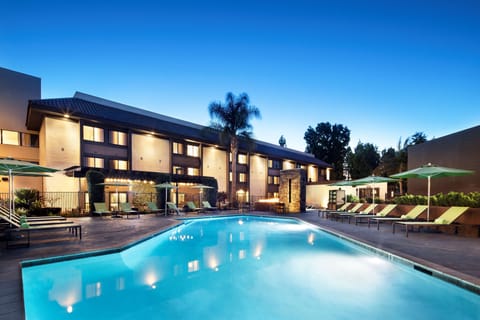 Outdoor pool, a heated pool, pool umbrellas, sun loungers