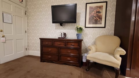 Room 213-Queen Bed No Windows | Living area | 42-inch flat-screen TV with cable channels, TV, iPod dock