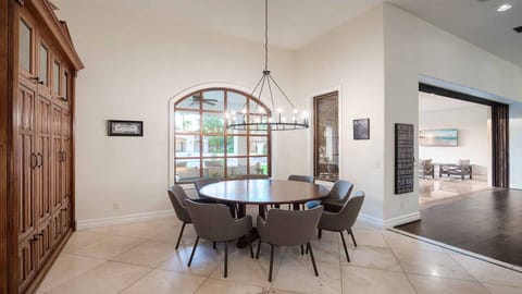 Round dining table seating 8 people next to the kitchen w/ backyard views