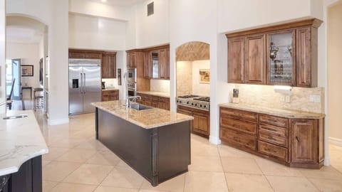 Chef’s kitchen with high-end appliances, granite counters, and custom cabinets.