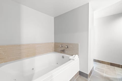 Suite, 1 King Bed (Bath Walk-In Shower) | Bathroom | Combined shower/tub, free toiletries, hair dryer, towels