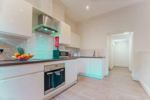 Deluxe Studio | Private kitchen | Fridge, microwave, oven, dining tables