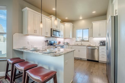 Bright, modern kitchen with spacious breakfast bar seating