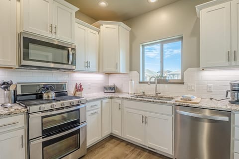 Bright, modern kitchen with stainless steel appliances and ample storage