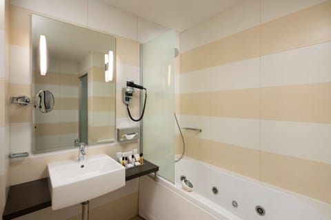 Deluxe Room, 1 King Bed | Bathroom | Eco-friendly toiletries, hair dryer, bathrobes, slippers