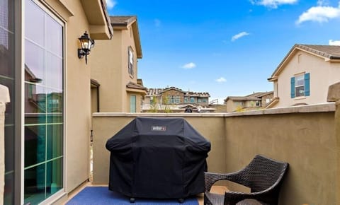 Outdoor patio featuring a grill and a bench