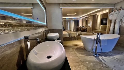 Signature Suite | Bathroom | Deep soaking tub, rainfall showerhead, free toiletries, hair dryer