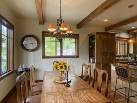 Dining table in front of large window looking at Baldy Mountain