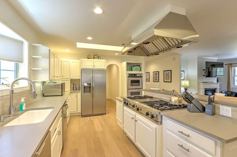 Chef's kitchen with gas stove top and double ovens