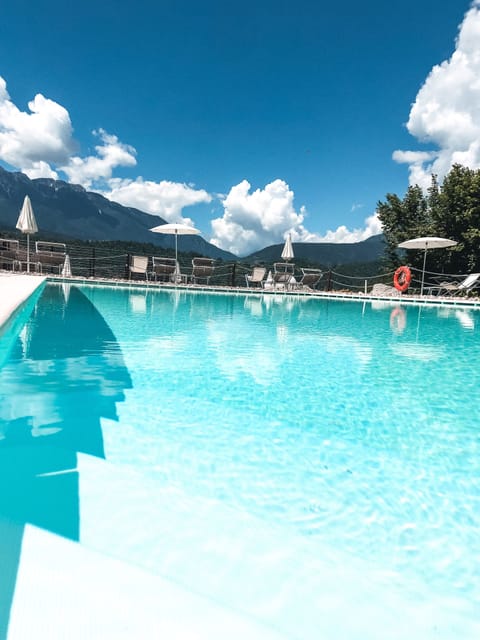 Seasonal outdoor pool, a waterfall pool, pool umbrellas, sun loungers