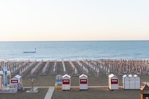 Private beach, white sand, sun loungers, beach umbrellas