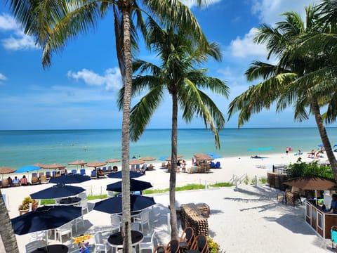 On the beach, white sand, sun loungers, beach umbrellas