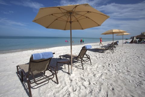 On the beach, white sand, sun loungers, beach umbrellas