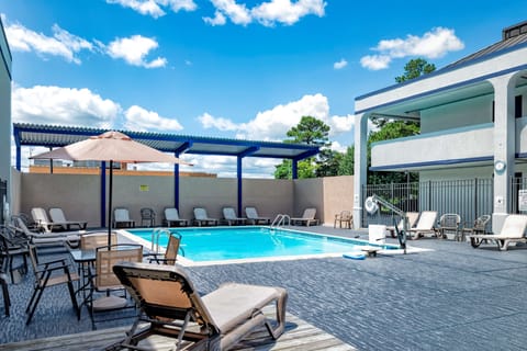 Seasonal outdoor pool, open 9:00 AM to 9:00 PM, pool umbrellas
