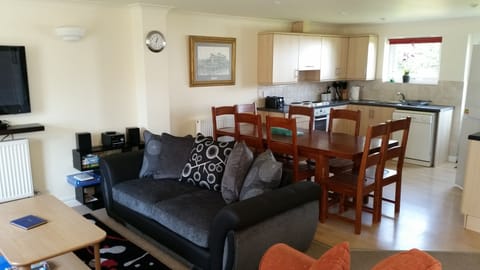 Open plan living area with brand new utensils and crockery