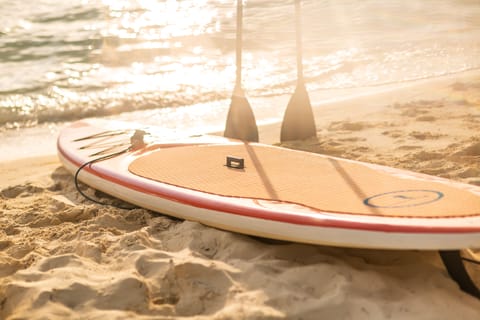 On the beach, white sand, sun loungers, beach umbrellas