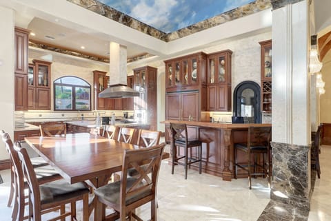 Entertainer's dream! Gourmet kitchen with bar, granite & wine storage.