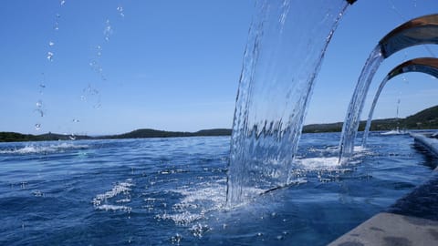 Seasonal outdoor pool, open 8:00 AM to 11:00 PM, pool umbrellas