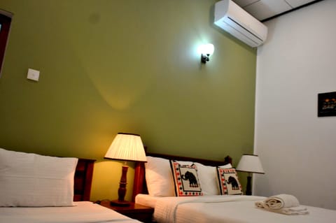 Deluxe Quadruple Room, Private Bathroom, Garden View | Minibar, in-room safe, desk, soundproofing