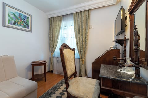 Superior Double Room | Living area | TV, DVD player, books