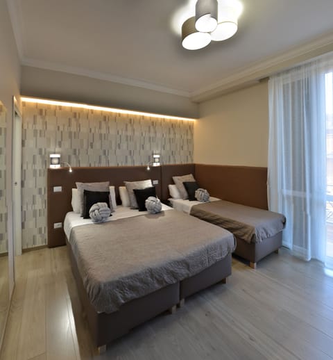 Triple Room | Select Comfort beds, in-room safe, desk, blackout drapes