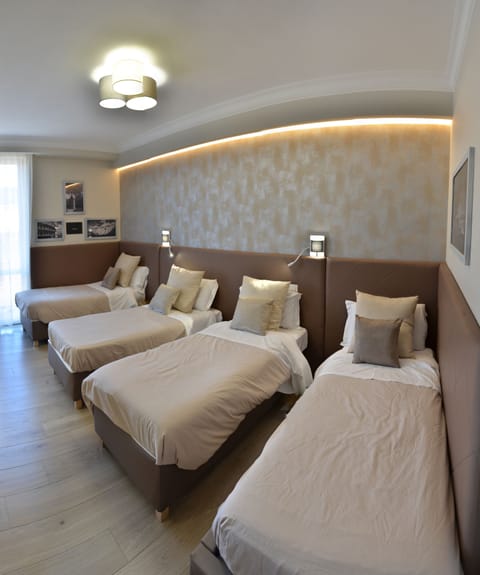 Quadruple Room | Select Comfort beds, in-room safe, desk, blackout drapes