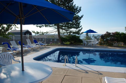 Seasonal outdoor pool, open 8:00 AM to 10:00 PM, pool umbrellas