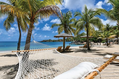 On the beach, white sand, sun loungers, beach umbrellas